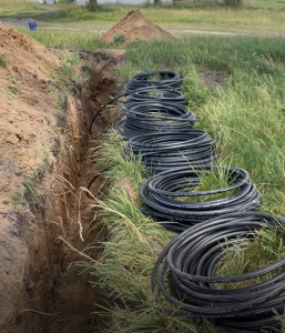 Plastic tubing placed near trench.