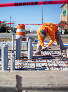 Worker preparing electric vehicle charger site