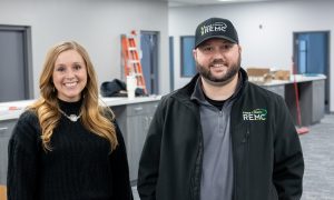 Two people standing in a newly completed office